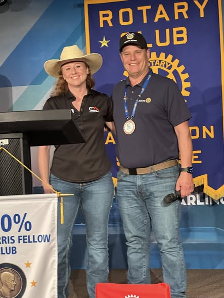 Two Arlington Sunrise Rotarians recognized on stage at the 100 percent Paul Harris Fellow club celebration