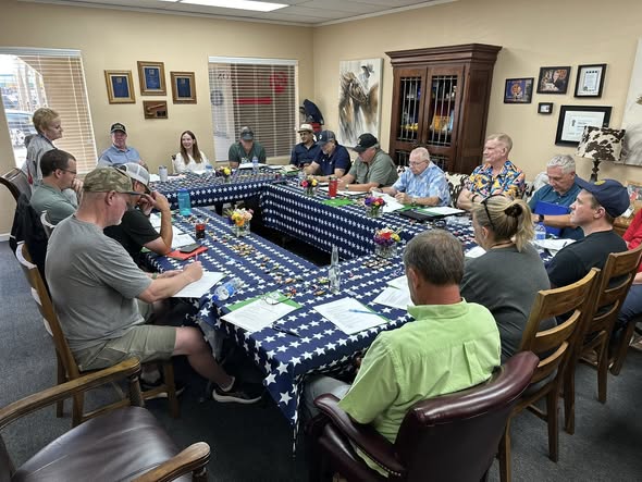 Arlington Sunrise Rotarians meet around star-print tables at a club meeting