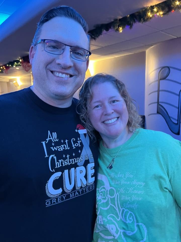Two Arlington Sunrise Rotarians in festive shirts at the holiday party
