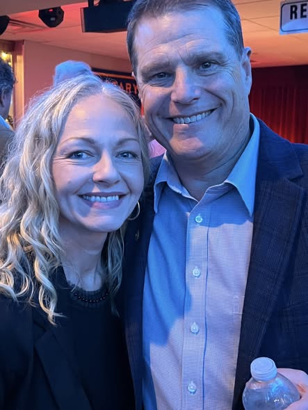 An Arlington Sunrise Rotary couple smiles at the holiday party
