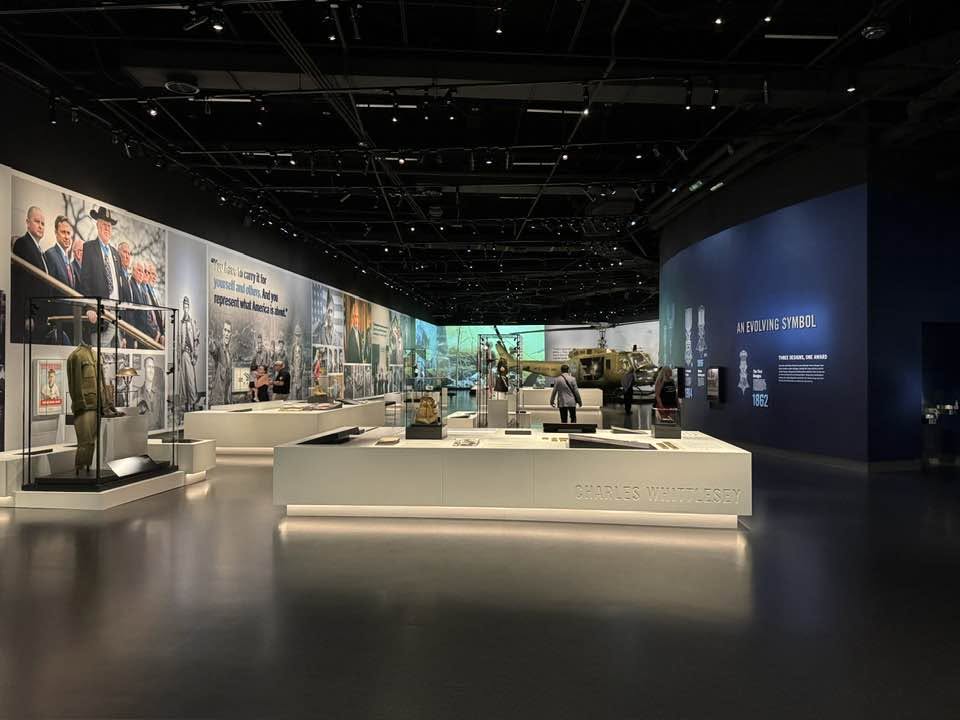 Arlington Sunrise Rotarians tour a museum exhibit hall on a club outing