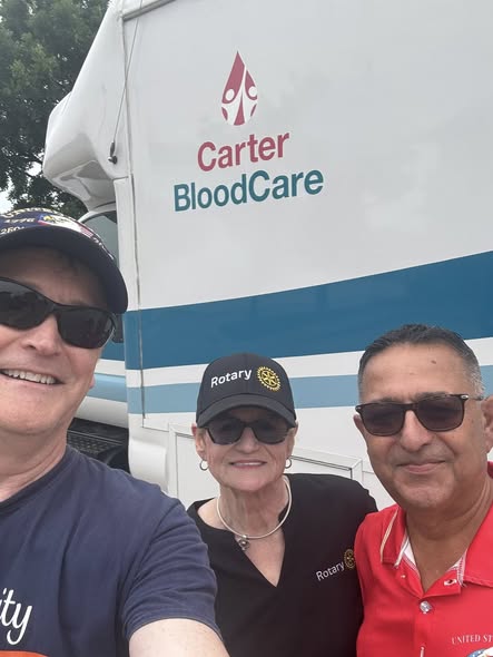 Arlington Sunrise Rotarians outside the Carter BloodCare bus at a community blood drive