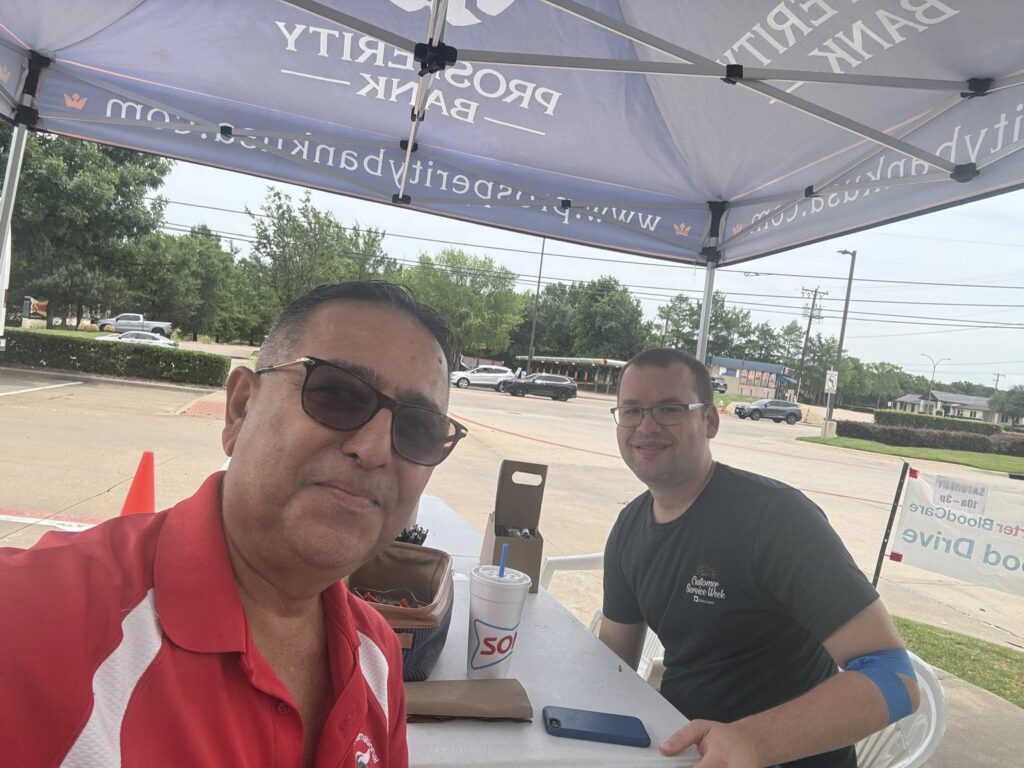 Arlington Sunrise Rotarians welcome donors under a tent at the community blood drive