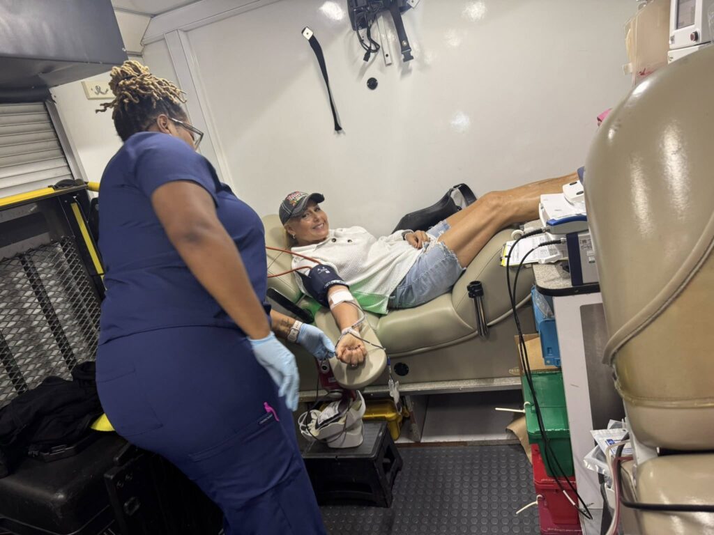 A Carter BloodCare phlebotomist assists a donor at the Arlington Sunrise Rotary blood drive