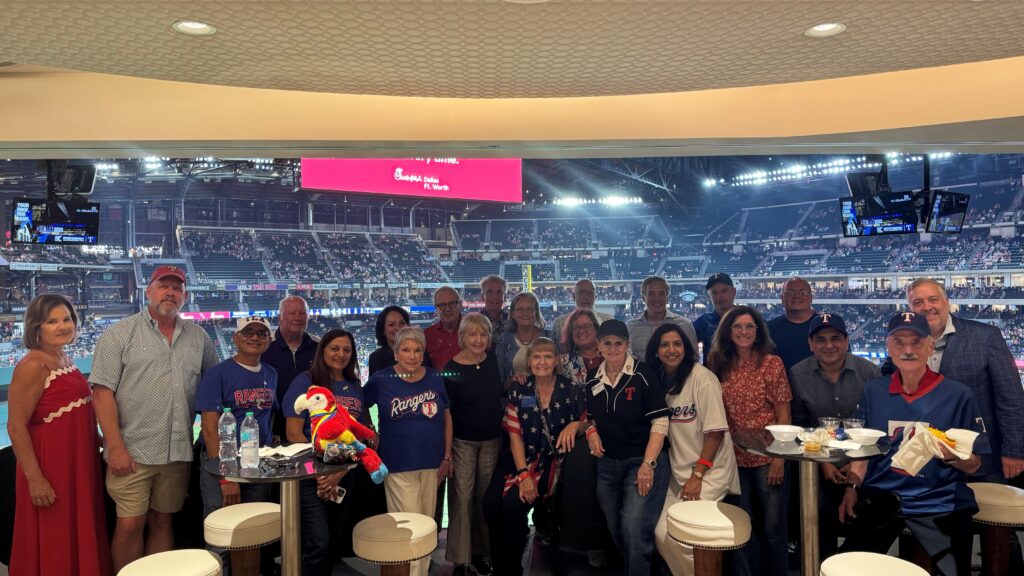 Rotarians and Rotary Foundation supporters gather in a suite at Globe Life Field for a Texas Rangers game